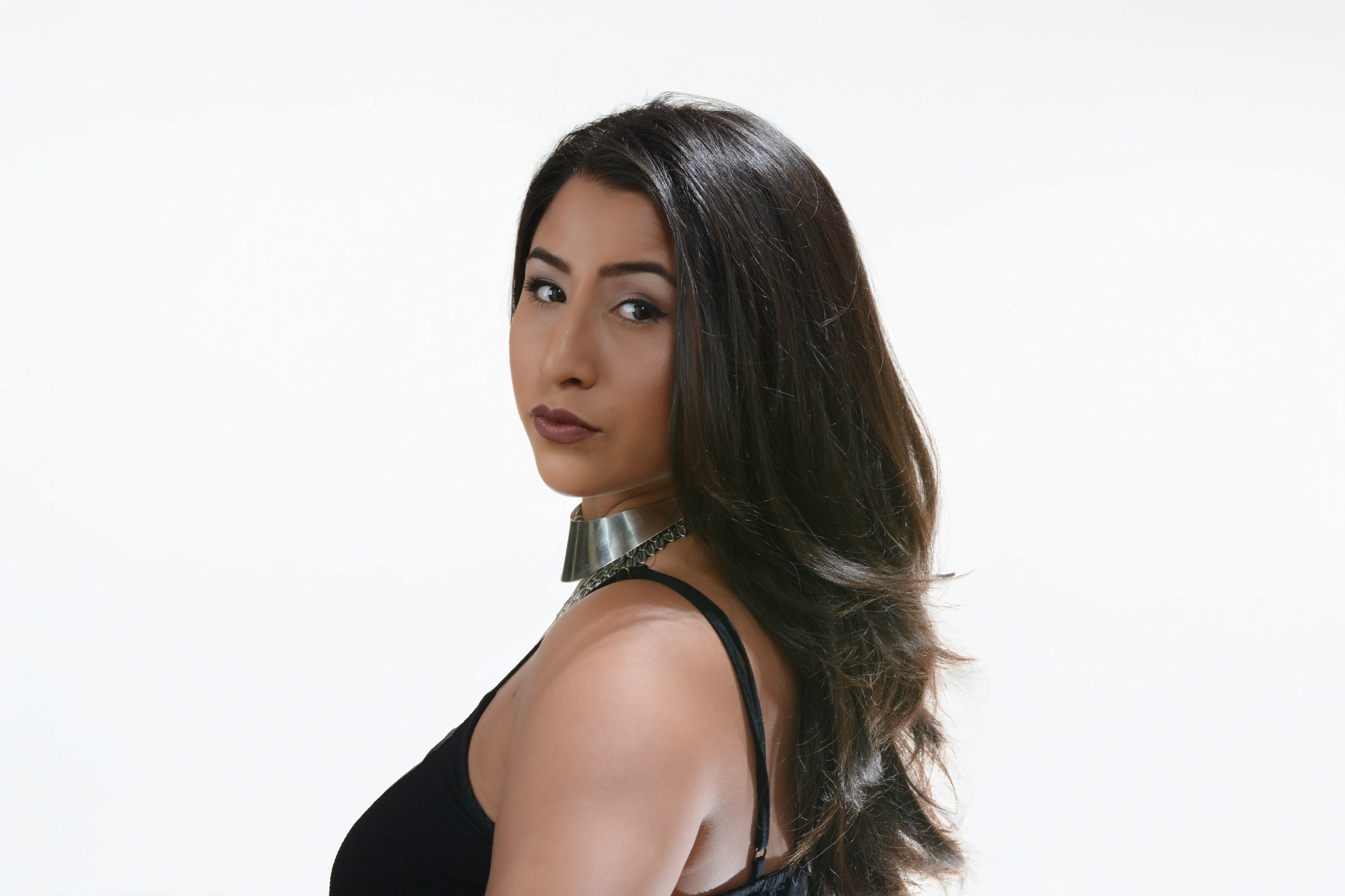 Long, glossy brunette hair with sleek styling by Holden Allen